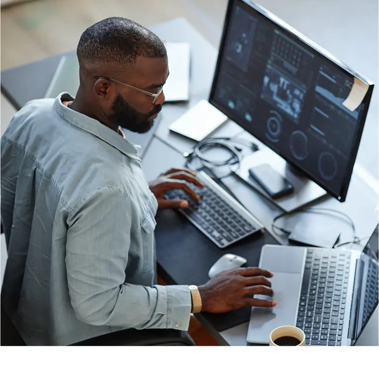 Person using laptop and external monitor